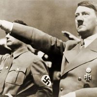 Adolf Hitler, giving Nazi salute. To Hitler's right is Rudolph Hess. 1939.