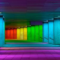 Colorful mulitcolord illuminated gallery tunnel rainbow passage under NAI building, Netherlands Architecture Institute near Museum Park, Rotterdam, The Netherlands