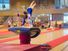 Young gymnast girl performing jump on a vault while practicing for the competition