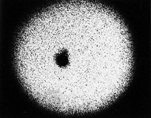 One of the discovery photographs of Pluto's moon Charon, taken at the U.S. Naval Observatory station in Flagstaff, Ariz., in 1978. Charon appears merely as a bulge on the upper right portion of Pluto's silhouette.