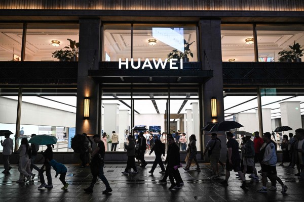 People walk past a Huawei shop in the Huangpu district of Shanghai on June 5, 2024. Photo: AFP