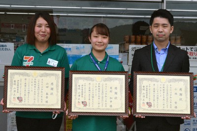 店舗前で感謝状を手にする3人＝三重県伊賀市のセブンイレブン伊賀平野北谷店で、大西康裕撮影