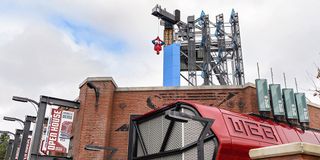 Spider-Man hanging over Avengers Campus