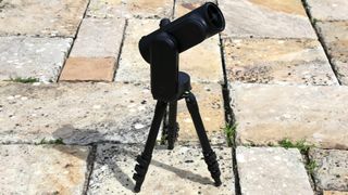 Unistellar Odyssey Pro telescope on a tripod outside on a tiled floor