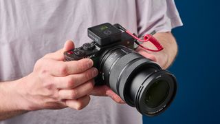 The Rode Wireless Pro microphone attached to a Lumix S9 camera being used to shoot video