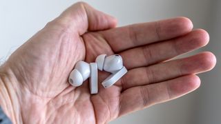 OnePlus Nord Buds 2 earbuds loose in hand.