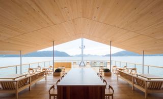 outside seating area on a hotel boat with wooden floors and decor