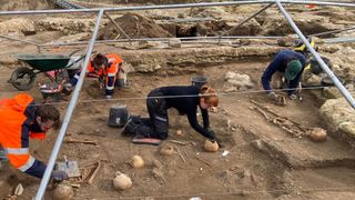 Excavation of archaeological site with four researchers.