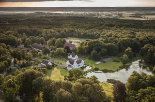 Wanås aerial view, with building and landscaped grounds amid forest