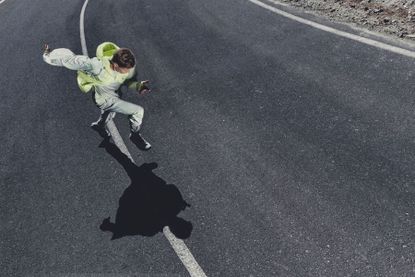 Man running on road wearing On PAF running gear