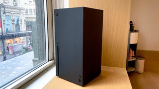 a photo of the xbox series x upright