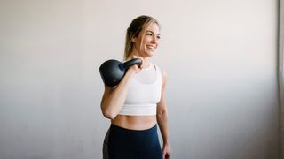 a photo of a woman holding a kettlebell