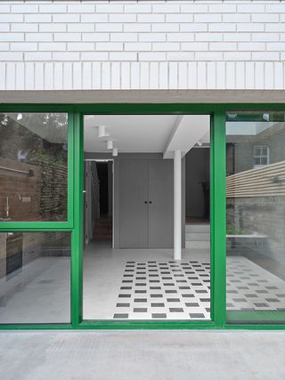 green window frames on white wall