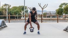 black man holding kettlebell outside half squat position