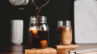 Pouring cold coffee into glass jar