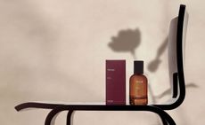 Aesop Rozu perfume on a Charlotte Perriand chair