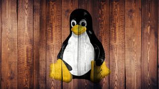 Linux penguin logo on wood.