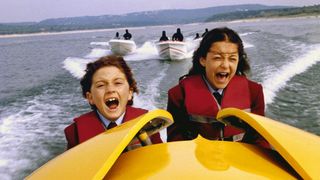 (L, R) Daryl Sabara and Alexa Vega as Juni and Carmen Cortez, in a speedboat in Spy Kids