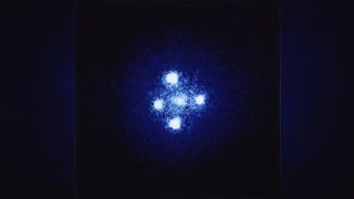 graphic illustration of four bright blobs surrounding a cluster of bright specks, glowing light blue and white.