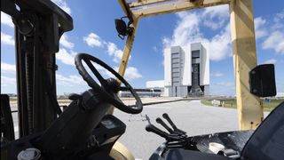 The mobile launcher with NASA’s Space Launch System (SLS) rocket and Orion spacecraft aboard is seen inside the Vehicle Assembly Building during the opening of the doors to High Bay 3 before rolling out to Launch Complex 39B for the first time, Thursday, March 17, 2022, at NASA’s Kennedy Space Center in Florida.