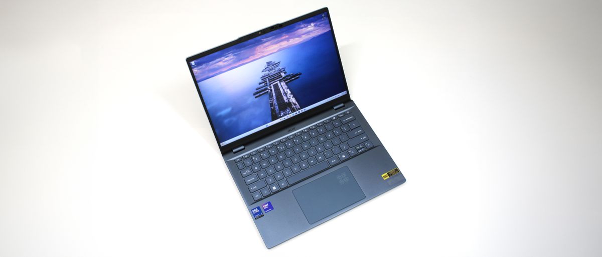 Acer Swift 14 AI (Intel) sitting on a white background with the display open showing the keyboard and touchpad