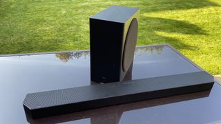 Samsung HW-Q800C soundbar and subwoofer on a black table