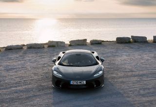 McLaren car at sunset beside sea