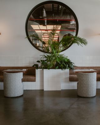 circular mirror reflects hotel interior