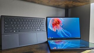 The Asus Zenbook Duo laptop photographed on a wooden desk.