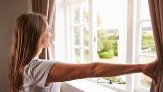 Woman opening a window