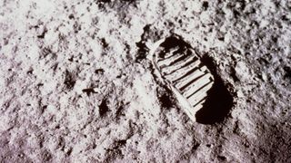 close-up of dust on the moon's surface with a bootprint visible at right