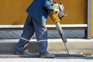 Worker jackhammering (shutterstock)