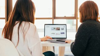 Two women look at a website and wonder what is web hosting?sting