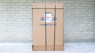 The Haworth Fern office chair fully assembled in a large box