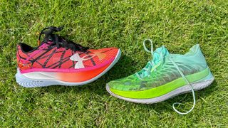 Under Armour Velociti Elite 2 and Under Armour Velociti Elite running shoes on grass