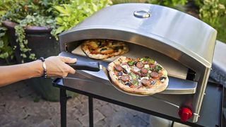 Camp Chef Italia Artisan Pizza Oven cooking pizza