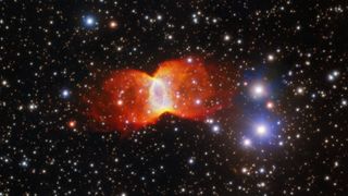 An image of an orange nebula shaped like a butterfly