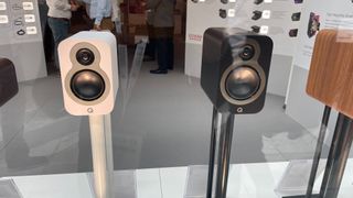 Q Acoustics 3010c in white finish and Q Acoustics 3020c in dark wood finish speakers on display