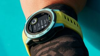 Women's wrist wearing Garmin Instinct 2S Surf Edition