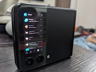 A demonstration of CoverScreen OS working on the Samsung Galaxy Z Fold 3, showing a list of conversations vertically