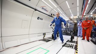 The chief instructor of European astronauts pulling the Lunar Equipment Support Assembly during a parabolic flight simulating lunar gravity.