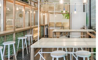 The architects have installed a transparent greenhouse-cum-kitchen in the airy dining room