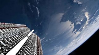 Earth is seen in the background. In the foreground, starlink satellites look stacked prior to deployment.