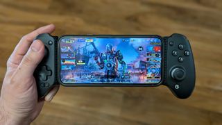 GameSir G8 Plus in-hand with phone playing Call of Duty Mobile