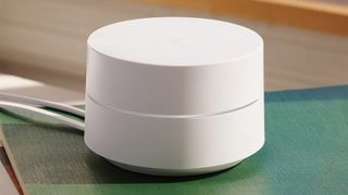 A Google Wifi Point Device Sitting On A Coffee Table