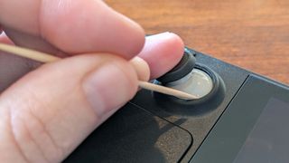 Cleaning Steam Deck joysticks with a toothpick.