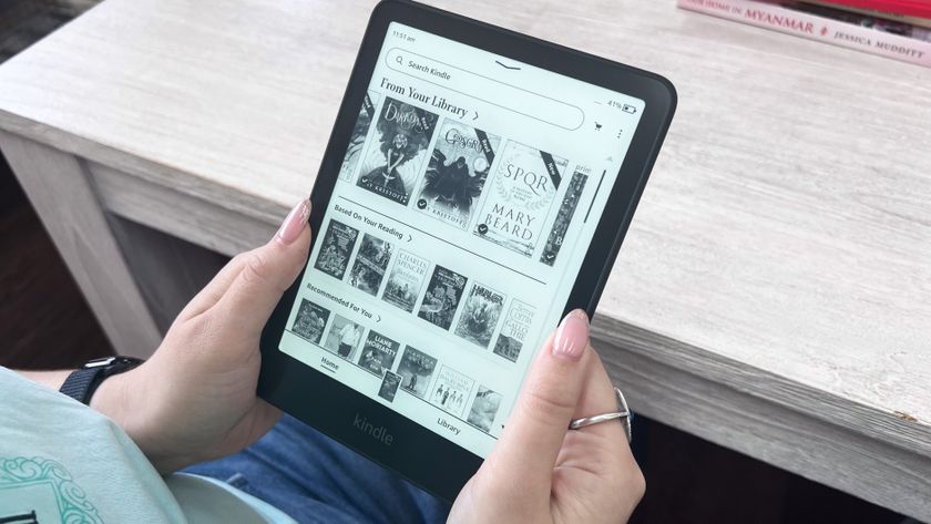 A person holding the Amazon Kindle Paperwhite (2024) with the Home screen displayed