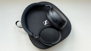 Sennheiser Momentum 4 Wireless headphones with case on window seat at reviewer's home