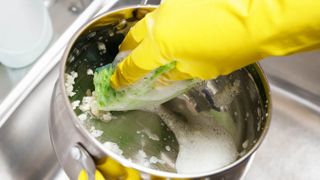 Cleaning pot with soapy water