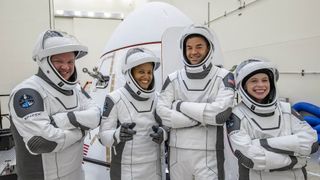 The Inspiration4 crew pose with their Crew Dragon spacecraft.